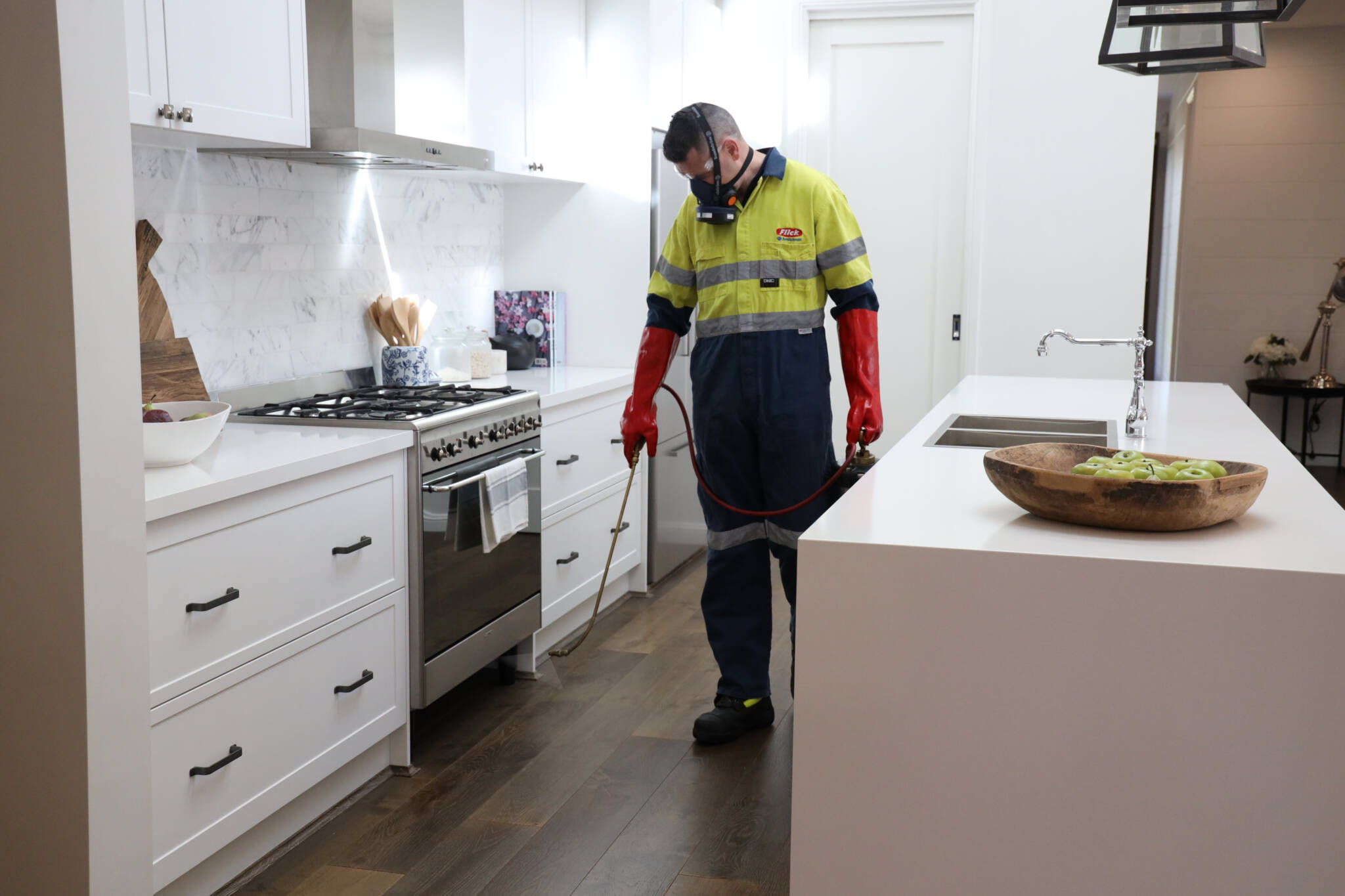 Brisbane Technician Spraying Kitchen for Cockroaches